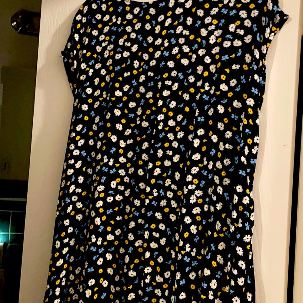 Navy blue background with white and yellow and blue flowers